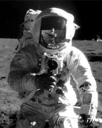 Photo taken by Apollo 12 pilot, Alan Bean. The photo shows Chief Pete Conrad, who himself is photographing Bean. Bean's image appears in the center of Conrad's helmet. The photographer is inside the case