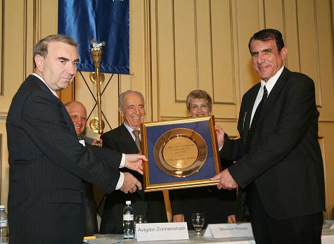 In the photo: Nissim Hadas - CEO of Elta Systems (right) and Yaakov Katsav - Head of Quality Administration at Elta (left) receive the National Quality Award. On stage: Mrs. Ziva Patir - CEO of the Standards Institute and Shimon Peres - Deputy Prime Minister.