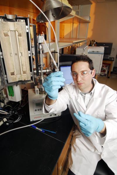 A Georgia Tech research student shows the material used to capture carbon dioxide from power plants