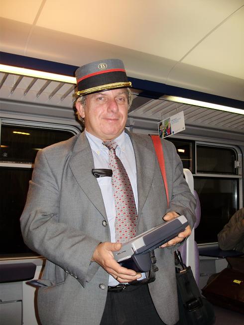 An elderly leprechaun, a ticket operator on the Belgian railway. Photographer: Roi Tsezana