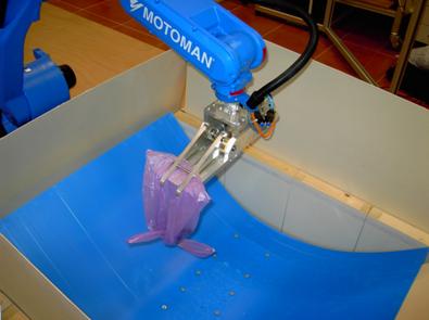 Figure 1. A robotic arm learning how to empty a bag containing non-conventional explosives (under laboratory conditions)