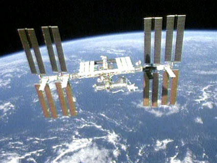 A silhouette of the shuttle Endeavor on the solar collectors of the International Space Station shortly after the shuttle detached from the station, on 28/7/2009