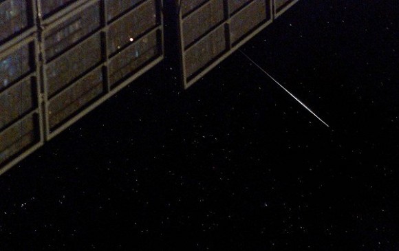 A flash of an Iridium satellite pointing the sun's receptors towards the camera and therefore appearing as a band of light, as photographed from the International Space Station. Don Pettit archive photo, NASA