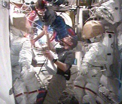 Astronauts Rex Wallheim and Stanley Love prepare for the third spacewalk, February 14, 2008