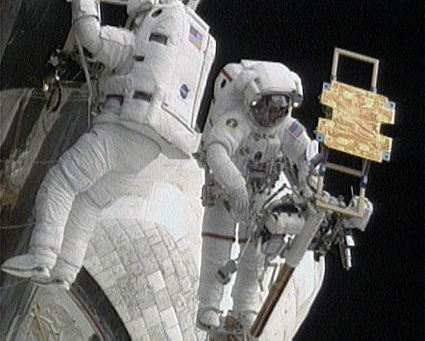 Drew Feustel (left) and John Grunsfeld on the fifth spacewalk. to the cargo deck of Atlantis to upgrade the Hubble Space Telescope, May 18, 2009