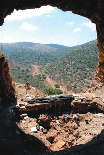 The excavation site of the Natufian cemetery in a cave overlooking Wadi Hilzon in the Western Galilee, photographed by Naftali Hilger, Weizmann Institute Magazine