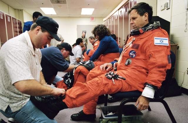 The late Ilan Ramon puts on the space suit during training, 2002. Photo: NASA