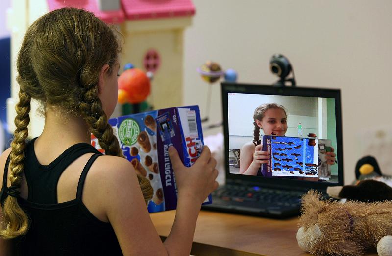 A girl plays in augmented reality with a Nestlé box. Photo: Dassault Systems Israel