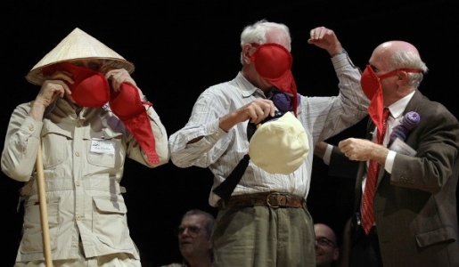 Three Nobel Prize laureates: Roy Glover (Physics 2005), Sheldon Glashaw (Physics, 1979), and James Muller (Peace, 1985), were captured demonstrating one of the winning inventions from 2009 - a bra that turns into a gas mask, at the 2010 Ignobel Awards ceremony.