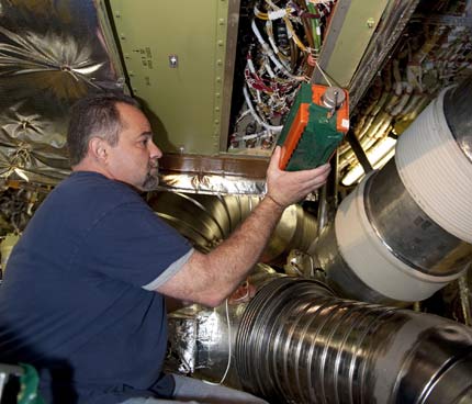 A technician works on repairing the damaged part of the space shuttle Endeavour, 06/5/2011