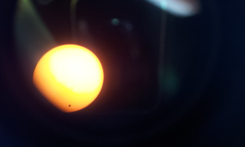 The transit of Venus (at the bottom of the sun) as photographed using a 12 inch telescope, a direct photograph into the eyepiece of the telescope and the sun using a filter. The photo was taken from the lobby of the Asher Space Research Institute at the Technion. Photography: Lial Asraf