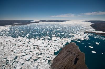 Looking down Ilulissat Fjord towards its source, where the Jakobshavn Isbrae Glacier loses ice to Okiranus. The fjord is studded with glaciers along its entire length (60 kilometers). Photo by Ian Joughin, University of Washington