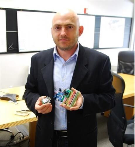 Peter Peltzer, CEO of NanoSatisfi holding the satellite's imaging and measurement equipment Photo credit Evan Ackerman/DVICE