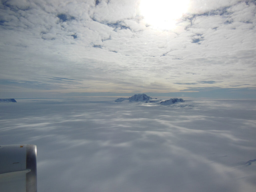 רק פסגותיהם של הרים רבים באנטרקטיקה נראים מעל שכבת הקרח העבה. צולם בפרויקט IceBridge, אוקטובר 2012. Credit: NASA / Christy Hansen)