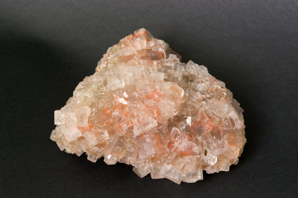 Rock salt from California. Photo: shutterstock. The pinkish-oval color of salt grains found in parts of the California and Nevada deserts is caused by "salt-loving" microorganisms called halobacteria.