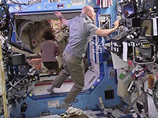 Luca Parmitano works inside the Destiny Lab with Karen Nyberg in the background in the Unity component. Photo: NASA TV