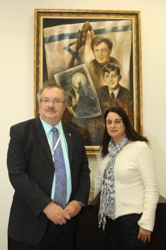 Bar-Ilan University President Prof. Daniel Hershkowitz with Rona Ramon with in the background the picture painted by the boy from Auschwitz that Ilan Ramon took with him to the Columbia ferry, a portrait of Ilan Ramon and a portrait of the Jewish boy Peter Gintz who painted the picture. Photo: Yoni Raif