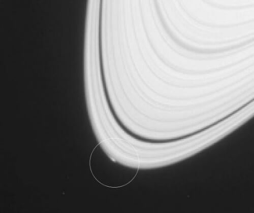 The disturbance seen at the outer edge of Saturn's A ring in the image taken by the Cassini spacecraft may be an object that is a moon in the process of formation. Photo: NASA