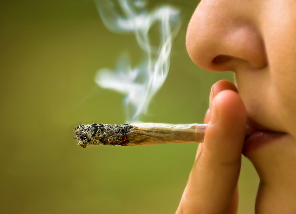 A young woman smokes marijuana. Photo: shutterstock