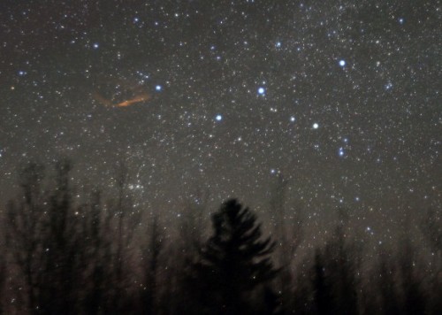 A 2.5 minute exposure showing the light trail left behind by an extremely bright Giraffe meteor. The five bright stars on the right are Cassiopeia's famous W. Photo: Bob King.