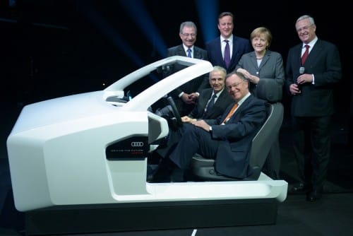 German Chancellor Angela Merkel and British Prime Minister James Cameron along with other participants in the opening ceremony of SAVIT 2014 unveil a prototype of an autonomous vehicle known as James 2025 developed by the Volkswagen Group. Photo by the public relations of the Hanover fairs.