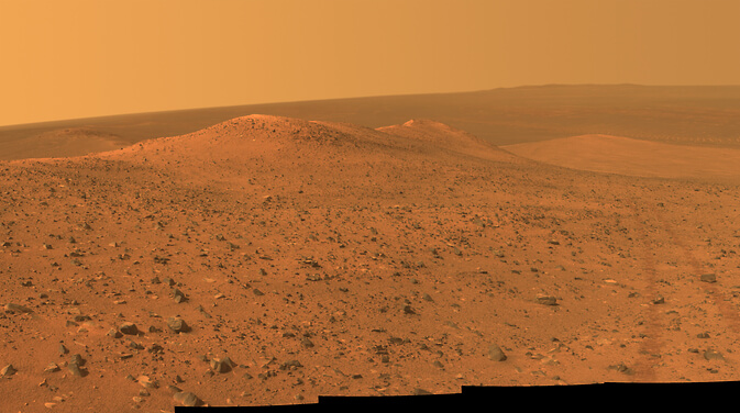 A panoramic view from the Oprotonite spacecraft reveals the Dubiak Ridge, looking north from left foreground to center. The footprints of the space vehicle in the field are visible on the right side of the image. Photo: NASA
