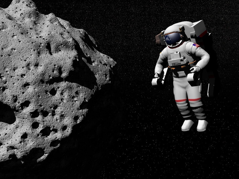 An astronaut hovers near a small asteroid. Illustration: shutterstock