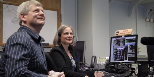 New Horizons Director of Operations Alice Bowman and operations team member Carl Wittenburg watch the information screens indicating New Horizons' transition from hibernation to operational status on December 6. Photo: NASA.