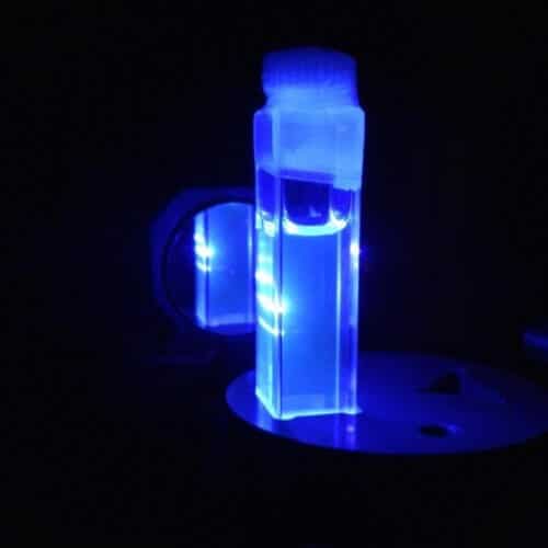 An image of a liquid solution emitting blue laser light. [Courtesy of CSIC and ASCR]