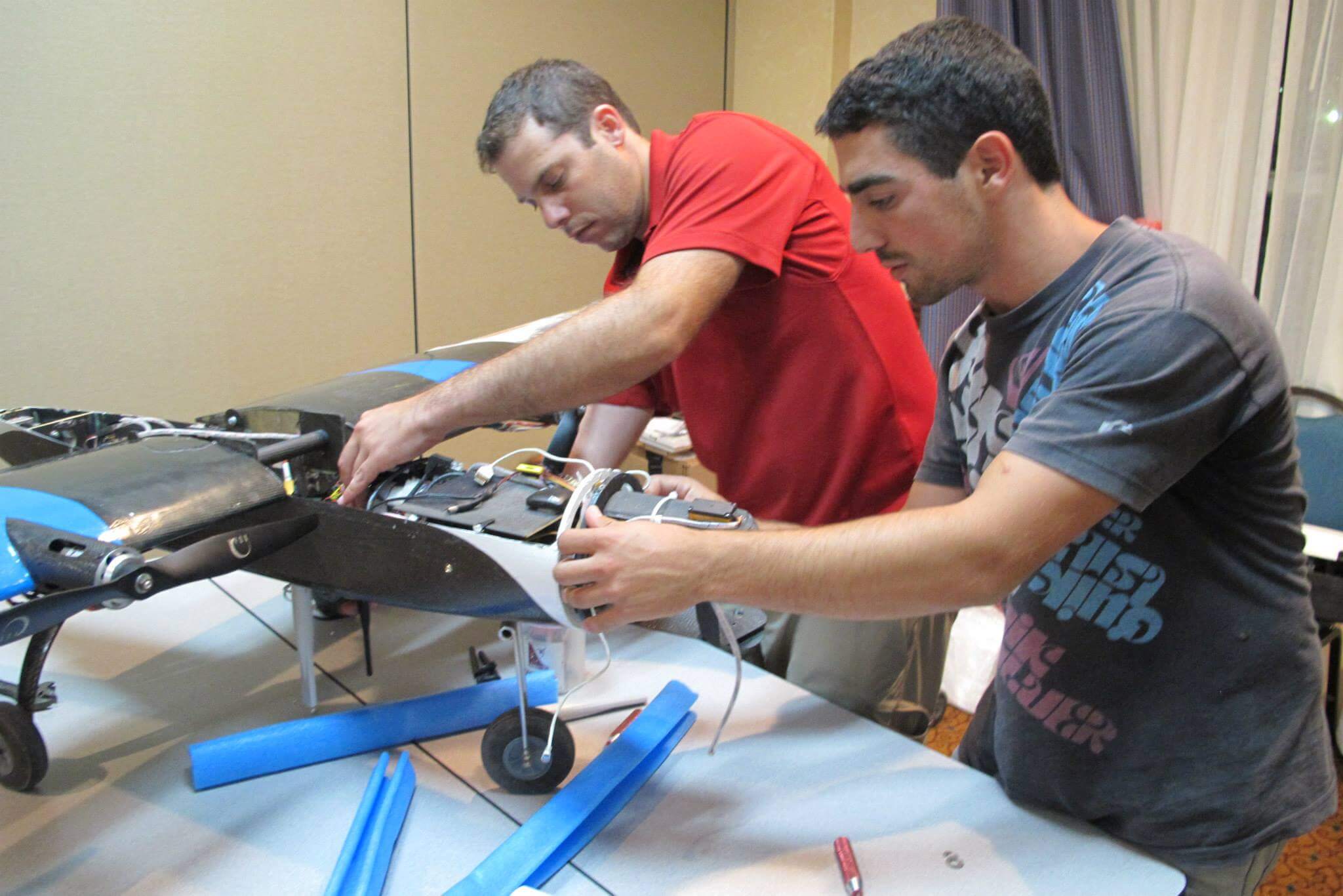 Niv Bacher (right) and Giv Yaari (group leader) work on the pilot vehicle