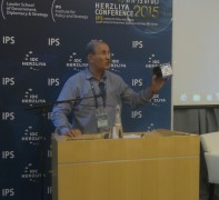 Brigadier General (res.) Haim Ashad holding a model of the Dokifat 1 satellite, at the Herzliya 2015 conference. Photo: Avi Blizovsky