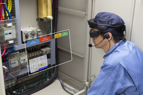 A technician uses the layered glasses to handle a complex system. Epson PR photo