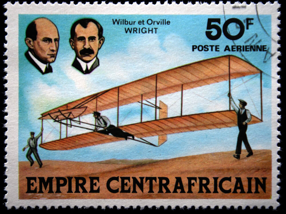 A stamp depicting the Wright brothers and their airplane. IgorGolovniov / Shutterstock.com