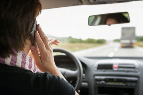 Talking on the phone while driving - distraction. Photo: shutterstock