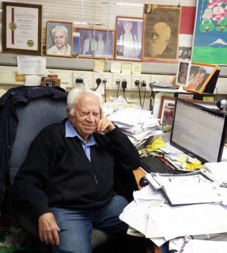 Prof. Nevo in his office. Behind him, a portrait of Charles Darwin watches over what is happening.