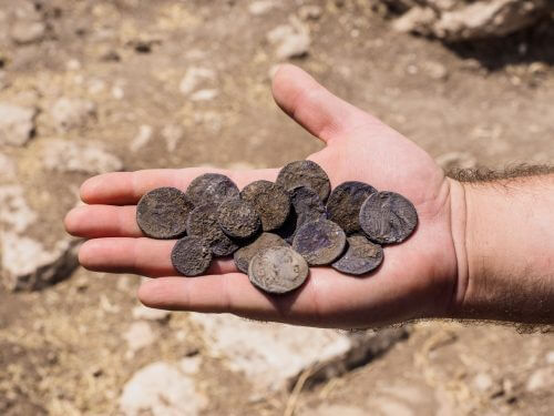 The cache of silver coins found in the manor house. Photo: Assaf Peretz, Antiquities Authority