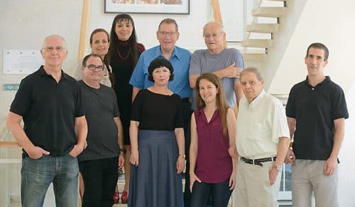 From the back, from the right: Dr. Yaacov Eshani, Prof. Yoel Zasman, Dr. Uri Diem and Dr. Tamar Ungar; in front, from the right: Dr. Sheral Fleishman, Prof. Israel Silman, Adi Goldenzweig, Dr. Shira Albek, Dr. Moshe Goldschmid and Dr. Haim Prilusky. Stabilization of proteins. Source: Weizmann Institute magazine.