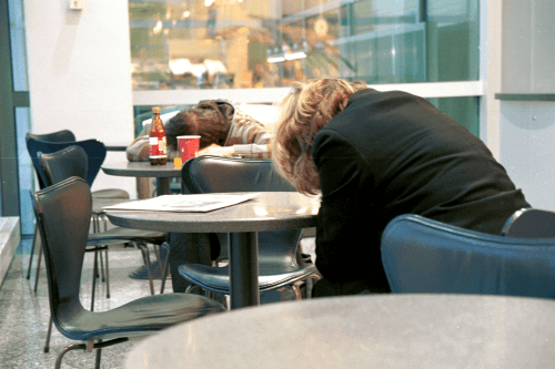 Exhausted passengers at an airport in Frankfurt, Germany, 2008. Photo: Alberto Vaccaro / flickr.