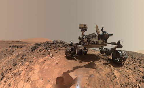 "Selfie" photo taken by Curiosity. In the background you can see Mount Sharp which stands in the center of Gale Crater, and Curiosity is currently climbing to its upper layers. To take selfies, Curiosity uses a camera mounted on its robotic arm, and takes pictures of itself from many angles. The images are then edited into a single image in Photoshop. Source: NASA/JPL-Caltech/MSSS.