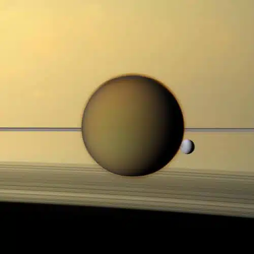 In the picture you can see Titan (the larger moon), which is the largest of Saturn's moons, and behind it the small moon Dione and Saturn's rings. It can be seen that Titan has a significant atmosphere surrounding it. The orange haze aloft in its atmosphere obscures the surface of the Moon in visible light. Titan's dense atmosphere and low gravity provide ideal conditions for flight. Photographed by Cassini in 2013.