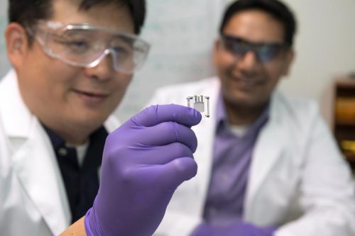 Lead researcher holds up a glucose-powered biofuel cell [Courtesy of Washington State University]