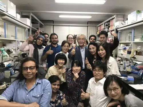 2018 Nobel Laureate in Medicine, Tsuko Honjo, surrounded by his research team in his laboratory at the University of Tokyo, just after the announcement of his 2018 Nobel Prize in Medicine. From his Twitter account