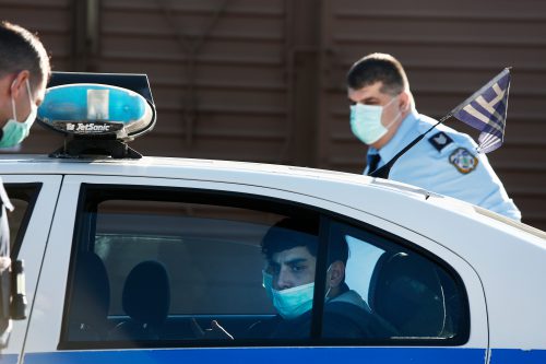 Arrest of an Afghan refugee discovered in a container in Thessaloniki, Greece, 31/1/2020. The refugee and the police wear a mask due to the fear of corona. Photo: shutterstock