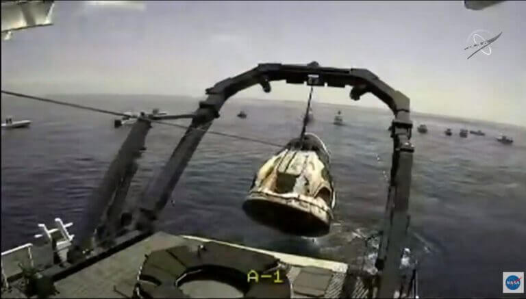 העלאת קפסולת הדראגון לספינת החילוץ. 2 באוקטובר 2020, שעה 22:16. צילום מסך מהטלוויזיה של נאס"א