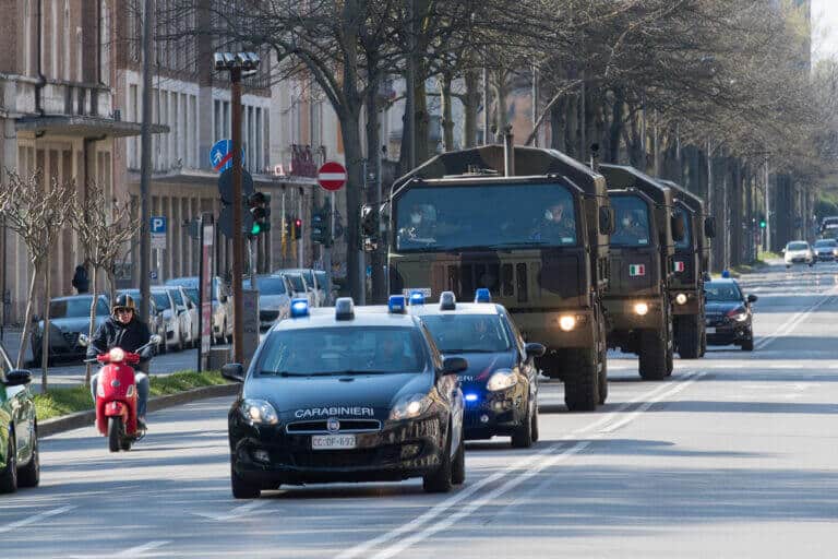 April 04, 2020. Italian army trucks transport the bodies of those killed in Bergamo (Italy) due to corona virus infection to the Shrine of the Fire in Ferrara, Italy. Photo: Shutterstock filippo.rubin