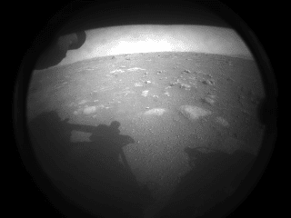 This is the first image transmitted from NASA's Persistence rover after touching down on the Martian soil on February 18, 2021. The view from one of Persistence's road cameras is partially obscured by dust cover. Photo: NASA / JPL-Caltech