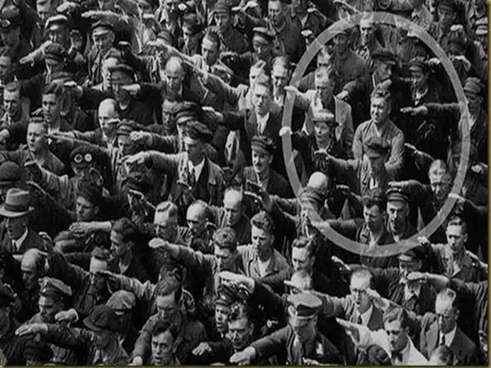 The power to say no! Hamburg 1936 Celebrations in honor of a new ship. The circled man does not do the well-known Nazi trick. The man's name is August Landmesser who was sentenced to two years of hard labor for marrying a Jewess. He chooses not to follow the consensus and the enthusiastic crowd.