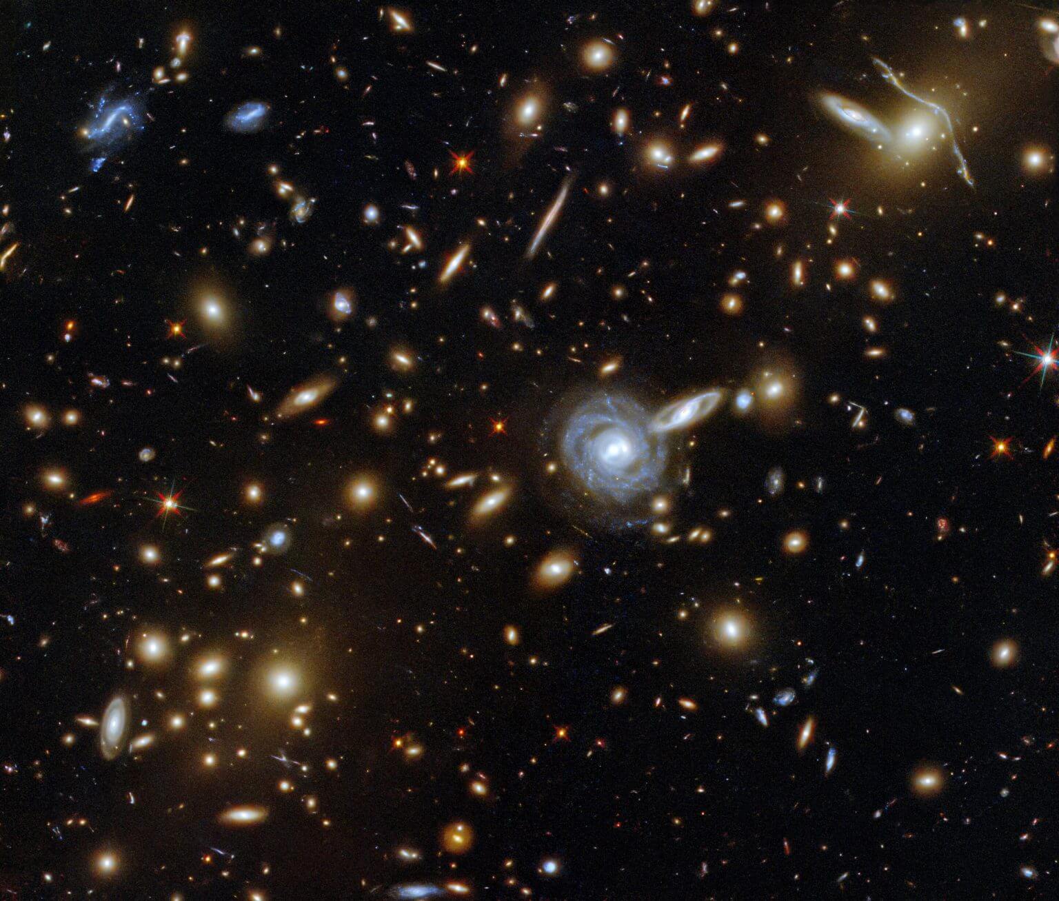 The galaxy cluster ACO S 295 imaged by the Hubble Space Telescope. Credit: ESA/Hubble and NASA, P. Pakud, D. Kua