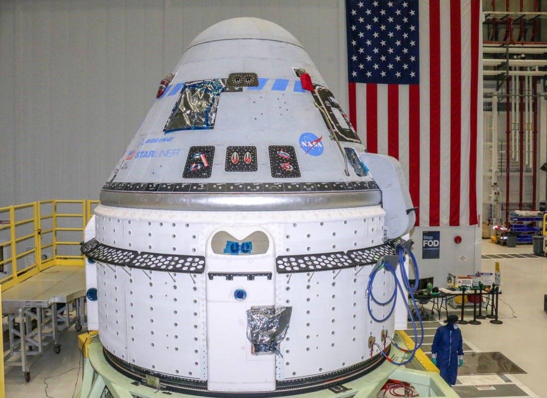 Technicians prepare Boeing's CST-100 Starliner for an orbital flight test (OFT-2) at the Commercial Crew and Payload Processing Facility at NASA's Kennedy Space Center in Florida on June 2, 2021. Credit: Boeing