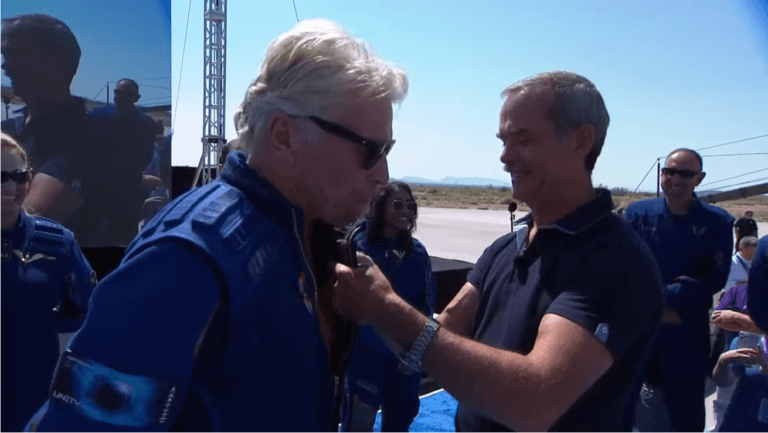 Former astronaut Chris Hadfield bestows space wings on Sir Richard Branson after the successful flight to the edge of space. Screenshot from the Virgin Galactic YouTube channel.